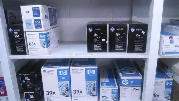 LaserJet printer cartridges on shelves